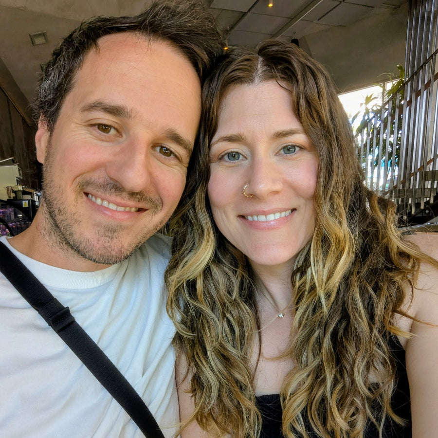 two people posing for a selfie, indoors